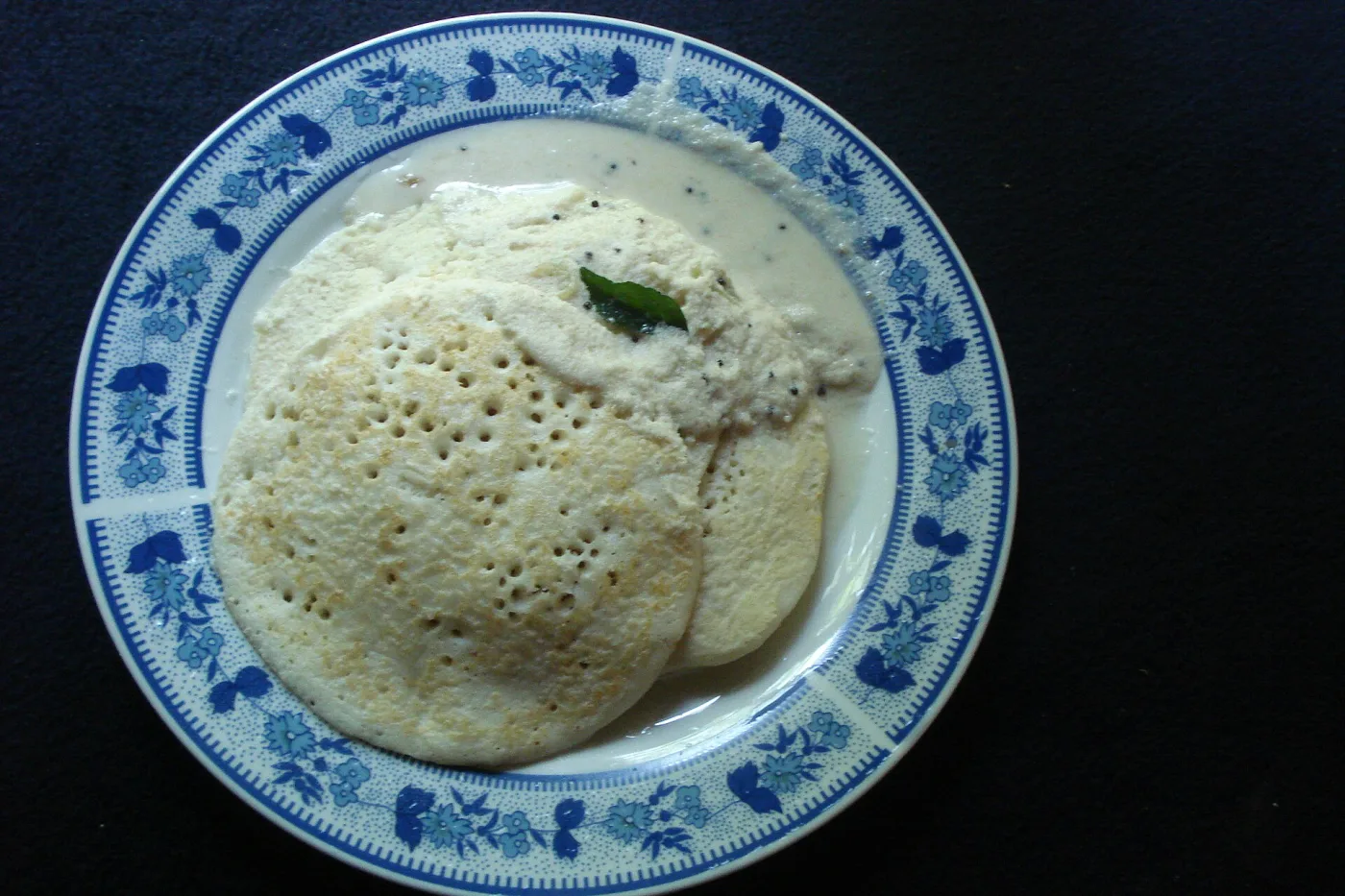 Southern Kerala dosa — thick, spongy, with coconut chutney.
