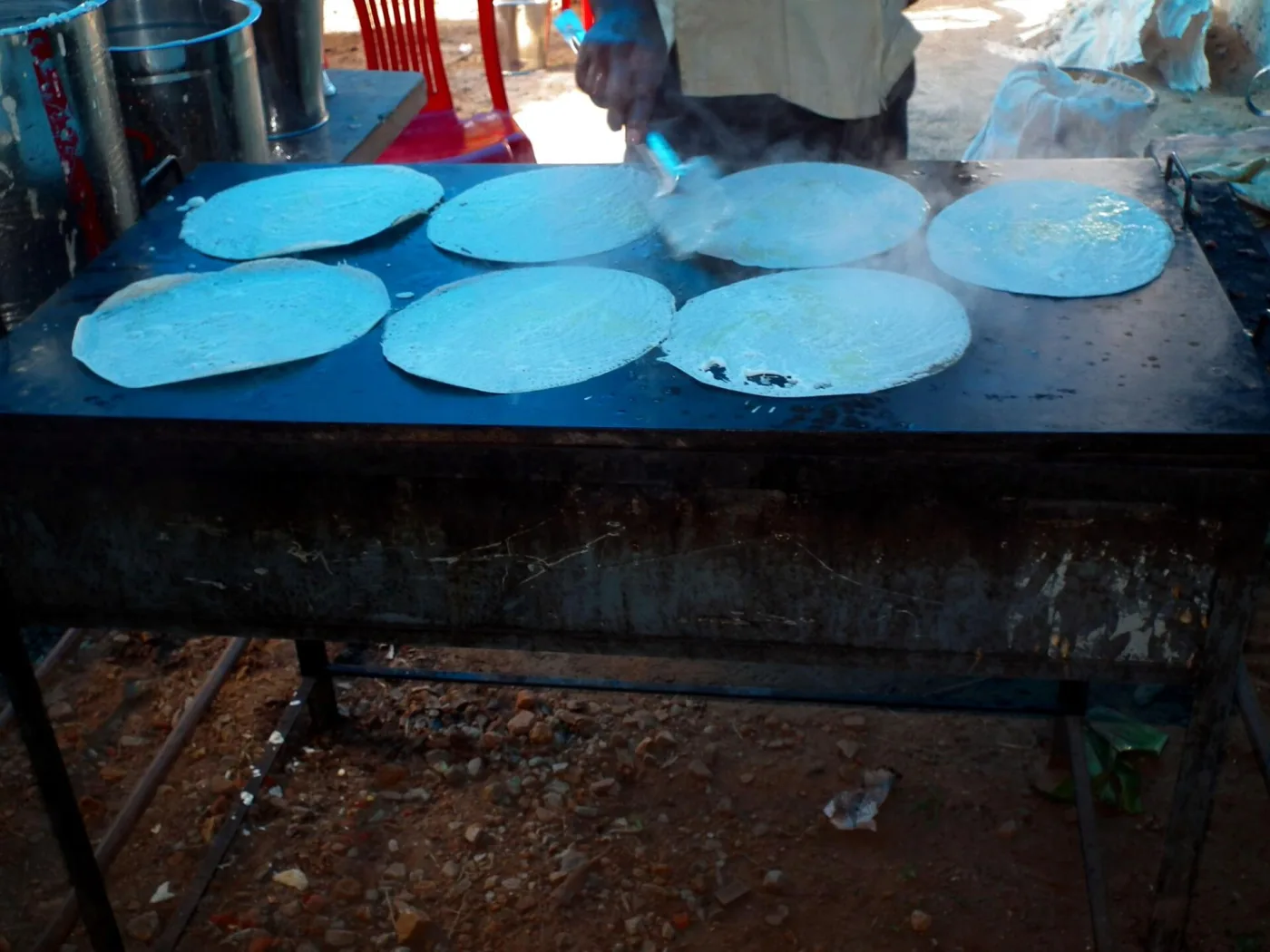 Thattu dosa — many crepes on a hotel griddle.