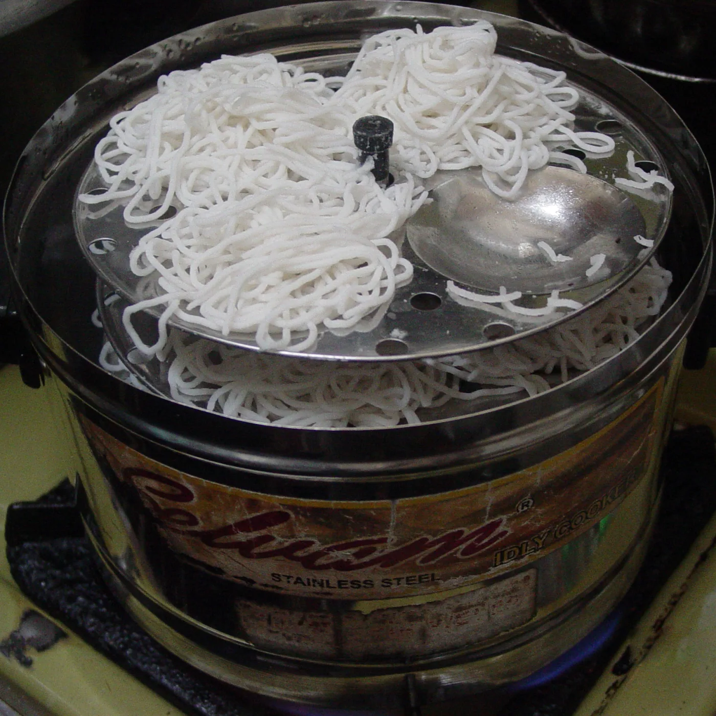 Nests steaming in an idli cooker.