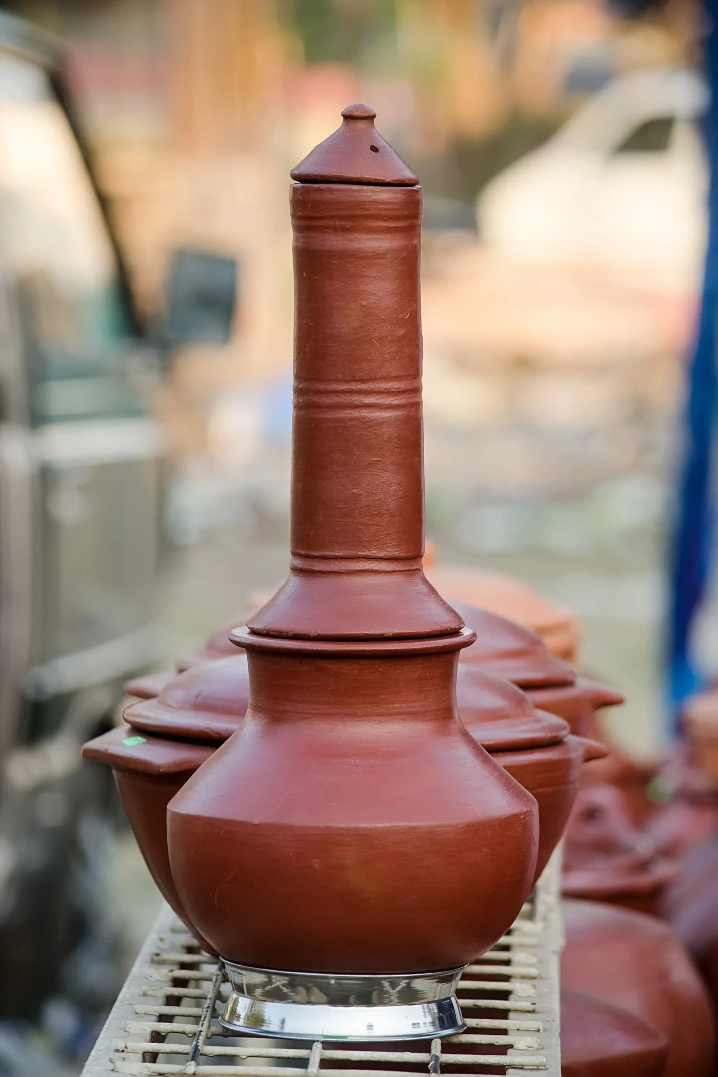 A clay puttu maker, with steam holes in the upper chamber.